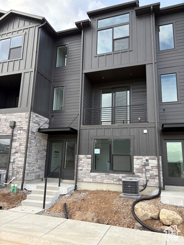 View of front of property with cooling unit