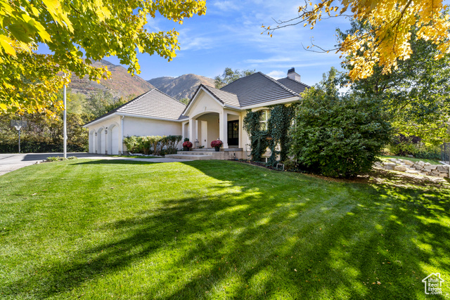 This stunning rambler home sits on a nearly one-acre lot in a prestigious Draper, Utah neighborhood, offering the perfect blend of privacy and luxury. With 5,110 square feet of living space, this fully finished home features six spacious bedrooms and three full bathrooms. The primary bedroom, located on the main floor, provides easy access to the heart of the home while offering a serene retreat.  Step outside to an incredible back patio, ideal for entertaining or relaxing, complete with a hot tub nestled in a private setting. The walkout basement leads to a sports court, perfect for active lifestyles. The home boasts a durable concrete tile roof, ensuring longevity and style.  For car enthusiasts or those needing extra storage, the property includes a spacious three-car garage and a state-of-the-art shop that can accommodate up to 12 cars, making it ideal for storing Class A motorhomes or any other prized vehicles. The neighborhood is renowned for its mountain views, proximity to great schools,  and walking distance to a trailhead which offers both beauty and convenience. Whether you're hosting a gathering or enjoying the peace of your surroundings, this home provides everything you need for luxurious, comfortable living.  Square footage figures are provided as a courtesy estimate only and were obtained from county records.  Buyer is advised to obtain an independent measurement.