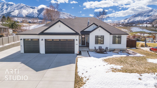 This beautiful rambler boasts exceptional curb appeal, perfectly situated on the North end of the Gladstan Golf course, just beyond the putting green of hole 4.  Its south-facing windows showcase breathtaking views of Loafer Mountain and Payson Canyon while the front of the house offers a magnificent panorama of Utah Vally and Utah Lake, creating a picturesque backdrop year-round. Adding to its prime location, the home overlooks a large future park set to be developed directly in front, ensuring unobstructed views and a serene setting. If you're up late enough, you might catch glimpses of Elk roaming just behind the house.    Tremendous amounts of natural light flood the interior through the expansive south-facing windows, filling the home with warmth and an airy ambiance throughout the day.  This thoughtful design not only enhances the bright and open feel but also perfectly frames the stunning mountain and canyon views, allowing you to enjoy the beauty of nature from the comfort of your living space. This meticulously designed landscaping features elegant rock work, enhancing the home's natural beauty. A private gate entrance provides direct access to the golf course, allowing for peaceful walks in the winter or cross country skiing right from your backyard.  Spanning over 4400+ sqft this home includes a fully permitted 3 bedroom 2 bath ADU in the basement complete with its own entrance, 9 foot ceilings and a generous living space--perfect for entertaining or as a rental opportunity.  Both levels have full kitchens with expansive islands making this home as functional as it is beautiful.