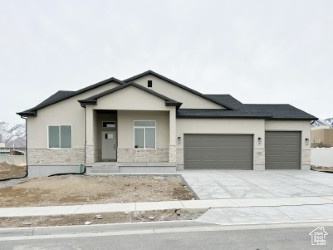 View of front of property with covered porch and a garage