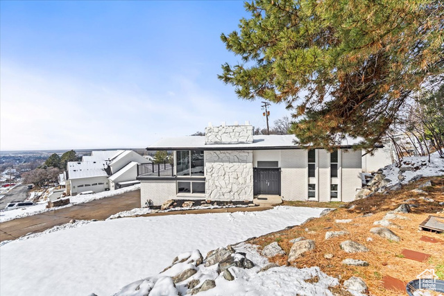 Mid-century modern home with brick siding