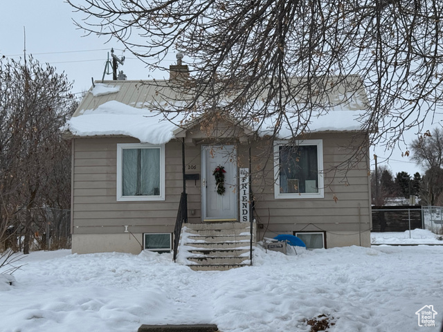 Bungalow-style house with entry steps and a chimney