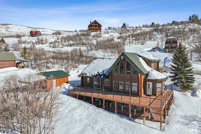 One of the best features of this home is the  heavy beam construction with real logs both inside and outside brings its solid presence in a convenient mid mountain location with access road all year round and ALWAYS plowed. Situated with views of a lake  and surrounding mountains, you can enjoy not only  the views seating in your cozy living room but from a newly built 1200 sqft Trex deck. The 5000 sqft  paved driveway with 50 amp service gives plenty spaces for not only your trailers and RV but also for guests coming to visit. An oversize garage plus a separate detached garage gives you plenty spaces for cars, toys or just extra storage. This house comes furnished with an oversized master bedroom with a fireplace and a large closet, newly renovated bathroom on the main floor. Kitchen has updated quartz countertops and new Bosch appliances. Loft has floor to ceiling windows, bar and pool table great for entertainment. High definition outside camera system, heat tape, 1000 gallon owned propane tank and a new 120K BTU heater with steam humidifier will keep  you cozy after a day of adventures in the surrounding grounds. If you are an outdoor lover, this house offers year round access to activities.  At your fingertips you can enjoy epic snowmobiling, dog sledding, skiing, bike riding and hiking and if you love water activities this place doesn't disappoint. The area is surrounded by reservoirs where water activities can be enjoyed.