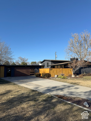 This stunning Mid-Century Modern home in Murray offers 1,750 sq. ft. of fully remodeled living space on a spacious lot with a large, fully fenced backyard-ideal for pets and outdoor entertaining. An oversized detached garage provides versatile space for storage or creative endeavors. Prime Location: Situated in a quiet, family-friendly community, the home grants quick access to highways, Fort Union shopping, dining, and schools like Woodstock Elementary and Bonneville Jr. High, all within walking distance. Chef's Dream Kitchen: Features luxury soft-close cabinets, stainless steel appliances (including a Bosch gas stove), quartz waterfall countertops, and modern snap-in flooring throughout the upper levels. Sophisticated Design: Highlights include a beautiful tile-accented wooden staircase, solid-core interior doors with craftsman-style casing, and elegant oil-rubbed bronze hardware. Spa-Like Master Suite: Boasts an oversized walk-in closet with frosted glass sliding doors and a custom-built shoe closet. The master bath offers a dual-head shower, custom tile work, a floating vanity, and designer lighting for a daily spa experience. Energy Efficiency: Upgraded windows with high energy standards, helping to maintain comfortable utility bills. The inviting front patio is perfect for morning coffee or evening relaxation. No detail has been overlooked in blending style, luxury, and comfort. Schedule your private showing today! Note: Square footage is an estimate from county records; buyers are advised to obtain an independent measurement.