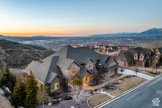 Custom 2-Story estate home featuring the best of city and mountain living.  Beautifully situated on the Draper East Bench, this home is right next to the Bonneville Shoreline Trail/Ann's Trail, tying into the coveted Corner Canyon Trail System.  Accessed right out your backyard, the trails are perfect for hiking, mountain biking and trail running.  The gourmet kitchen is a chef's dream, featuring high-end stainless steel appliances, granite countertops, and ample storage space. Whether you're hosting intimate gatherings or entertaining on a larger scale, the kitchen seamlessly flows into the dining area and living room, creating the perfect ambiance for socializing. Panoramic windows throughout the home capture breathtaking views of the surrounding mountains and valley, filling the space with natural light and enhancing the sense of tranquility. Step outside to the expansive deck, where you can enjoy al fresco dining or simply unwind while taking in the majestic scenery. The master suite is a sanctuary of comfort, boasting a spa-like ensuite bathroom with dual vanities, a soaking tub, and a walk-in shower. Six additional bedrooms provide plenty of space for family and guests, each thoughtfully designed with comfort and privacy in mind. The basement boasts a separate entrance to a mother-in-law apartment or ADU and even features one of the largest home theaters you will ever find.