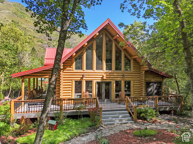 5981 E GRINDSTONE DR Springville, Utah Mountain Log Home Retreat Steps from Hobble Creek Golf Course. Escape to your dream mountain retreat in this fully remodeled log home, perfectly situated just steps from Hobble Creek Golf Course. This stunning property combines rustic charm with modern luxury, offering a lifestyle of comfort, relaxation, and adventure. Inside, you'll find a chef-worthy kitchen featuring Viking appliances, concrete countertops, and a marble island, along with high-end finishes throughout. The spa-like primary bathroom is designed with ultimate relaxation in mind. The finished basement provides ample space with a bedroom, bathroom, and kitchenette-ideal for guests or multi-generational living. Step outside to unwind in the private hot tub while taking in the breathtaking natural beauty. Watch deer and elk pass by from your primary bedroom balcony, or relax on over 95 feet of wraparound decking.For those with toys or visitors, there's plenty of parking with a two-car garage, a 14x22 three-sided carport, and a four-car circular driveway. Just minutes from the Uinta National Forest, this home offers the perfect balance of seclusion, comfort, and recreation-whether you're seeking a luxurious full-time residence or a peaceful vacation escape.Additional features include an 8x10 shed, antique leaded glass window, two furnaces, a wood-burning stove fireplace, gravel RV pad, all full logs (no abutted seams), two-foot overhangs, a fenced yard for dogs, custom elk front door window, wood-carved bear banister detail, antique 1900s vanity in the primary bath, a 220V outlet in the garage for an electric vehicle, and so much more.This rare find has recently been price-adjusted to move-don't miss your chance to own a piece of mountain paradise.