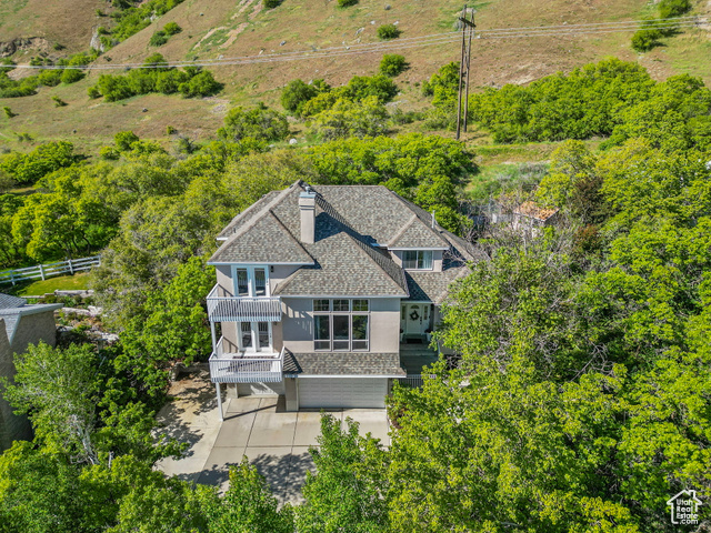 2032 SPRING OAKS DR Springville, Utah ****OPEN HOUSE, Friday, June 13th 4-6 pm**** Nestled within the sought-after Spring Oaks subdivision on Springville's east bench, this inviting residence offers remarkable valley views and the unique advantage of backing directly to the mountain landscape, ensuring exceptional privacy with no rear neighbors. This home features five bedrooms and three and a half well-appointed bathrooms. A dedicated office provides a functional workspace, while the spacious basement offers considerable storage options. The property's outdoor space seamlessly integrates with the natural environment. The backyard transitions into a natural grove of Scrub Oak trees, offering a distinctive area for outdoor activities. Two balconies provide elevated perspectives for enjoying the picturesque surroundings. The deck is ideal for both casual enjoyment and entertaining, extending the living space outdoors. The generous great room also accommodates larger gatherings with ease. Additional features include a designated dog run, a practical potting shed with seasonal storage capability, and a charming gazebo for outdoor relaxation. Residents will appreciate the direct access to nearby hiking trails and the close proximity to the recreational amenities of Hobble Creek Canyon, Hobble Creek Golf course, and Wayne Bartholomew Family Park. Square footage figures are provided as a courtesy estimate only and were obtained from County Records. Buyer is advised to obtain an independent measurement.