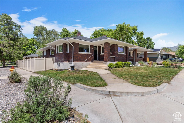 This well-cared-for corner-lot bungalow in Liberty Wells offers a rare blend of historic charm and modern comfort. The home has been thoughtfully maintained and improved over time, with attention to both aesthetics and function. From the moment you walk in, you'll notice how light, bright, and comfortable the spaces feel.  The basement features unusually high ceilings, a private entrance, large egress windows, a second kitchen, its own laundry, and plenty of natural light. Whether you're looking for rental income, a guest suite, or multi-generational living, this flexible space has you covered. Estimated rental potential is around $2,200 per month.  Upstairs, the original hardwood floors have been beautifully refinished and are complemented by timeless finishes throughout, including quality cabinetry, quartz countertops, and spacious closets that are hard to find in homes of this era.  The home sits on a solid foundation and has a great backyard setup with a full fence, a generous patio for entertaining, and a detached two-car garage that offers both storage and future potential for an ADU. There is also off-street parking for two more vehicles, which is a rare convenience in this neighborhood.  Located just minutes from Liberty Park, freeway access, and Salt Lake City's vibrant food and shopping scene. A wonderful opportunity for buyers seeking a move-in-ready home with character and income potential in a sought-after neighborhood.