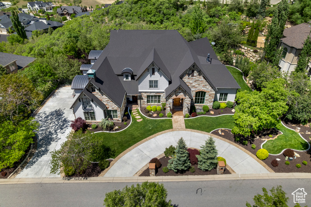 81 E LONE HOLLOW DR S Sandy, Utah Beautiful Custom Home Located in the Heart of the Prestigious, Guard-Gated Neighborhood of Pepperwood! The home was built with incredible attention to detail and features custom cabinetry and wood work throughout! This one of a kind floor plan includes a main floor primary bedroom suite, formal living and dining rooms, gourmet kitchen, great room and study. The additional bedrooms upstairs are all impressively unique and massive! The Basement is Perfect for Entertaining Featuring an Awesome Private Indoor Pool, Spa and Work Out Room, Giving You Access to Fun 365 Days a Year! There is also a second kitchen, spacious great room, huge theater room and two additional guest rooms! The Home boasts wonderful quality throughout! The professionally landscaped two-level yard is a showpiece, including incredible water features that make sitting on the back patio a delight! The perfect home designed for living, entertaining and relaxation! The Pepperwood Community has amenities second to none! You will find a private park and playground, community pool and hot tub, (even a competitive summer swim team). Basketball, pickleball, tennis, and volleyball courts, and miles and miles of walking trails. Pepperwood also holds community events throughout the year, from Easter egg hunts to Fourth of July parades to food truck nights. It is a great place to live and is conveniently located just minutes from world-class skiing, hiking and biking trails, top-rated schools, and the Salt Lake International Airport.*Buyer To Verify All Info.