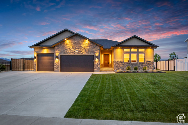 4857 W SMOOTH BORE LN Herriman, Utah This beautifully finished Herriman home features 10' ceilings upstairs and 9' in the basement, offering a bright, open feel throughout. The rentable walkout basement includes a full kitchen, washer/dryer hookups, separate furnace and A/C, and granite countertops-perfect for multi-generational living or rental income. Enjoy high-end quartz countertops in the main kitchen and master bath, 2 gas fireplaces, R-50 and sound barrier insulation for quiet, energy-efficient living. The 3-car epoxy-floor garage is fully finished with a workshop, storage, and extra electrical panel capacity for future EV charging. Outside, you'll find RV parking, a covered patio, fenced backyard with wrought-iron gates, and professional landscaping with a Basalt rock water feature and outdoor lighting. Smart upgrades throughout make this home as functional as it is beautiful.