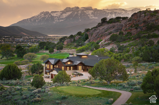 523 N RED CT Heber City, Utah Welcome to 523 N Red Mountain Court-an exceptional mountain estate located in the prestigious Red Ledges community. This 7,016-square-foot home combines sophisticated design with rustic elegance, offering panoramic views of the Wasatch Mountains and the renowned Jack Nicklaus Signature Championship Golf Course. Every detail of this home has been meticulously crafted for both relaxation and entertainment. The expansive open-concept layout features soaring vaulted ceilings, rich hardwood floors, and massive double-pane windows that frame breathtaking views. The gourmet kitchen is a true culinary masterpiece, featuring quartz countertops, custom cabinetry, and top-of-the-line appliances, with a wet bar perfectly situated for social gatherings.