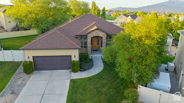 462 W ROSEMARY PL Saratoga Springs, Utah Tucked at the end of a quiet cul-de-sac in an established neighborhood, this home feels like a hidden retreat. Set on a third of an acre, the yard is a rare find-fully fenced with vinyl, lined with mature trees, and perfectly positioned to offer both privacy and mountain views. Whether you're tending the garden, shooting hoops on the backyard court, or hosting friends beneath the massive covered deck (complete with gas grill stub), this space invites living at its fullest. Inside, the home unfolds with clean lines, fresh paint, new carpet, and a sense of calm. Every listing you see claims immaculate condition, but this one truly is immaculate. The chef's kitchen anchors the main level with warmth and function, opening into airy gathering spaces and rich hardwood floors. Downstairs, a sprawling entertainment area offers room for every kind of connection. The master suite is grand in scale and feel, with details that elevate daily life, like a large jetted soaking tub, and dual shower heads. Craftsman finishes, wood-burning fireplace, extra-depth garage, and even an intercom system-all carefully maintained and move-in ready. Just 30 minutes from Salt Lake and 15 from Silicon Slopes, this is a home that balances convenience with quiet sophistication. The information found herein can be considered accurate, but any prospective buyer is encouraged to verify all information to their own satisfaction.