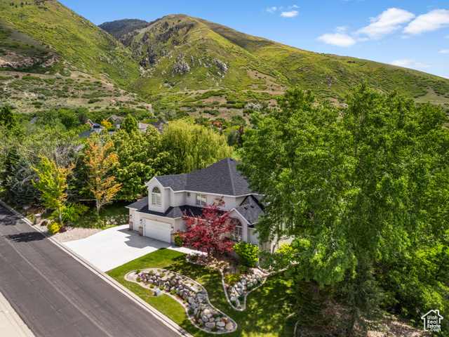 Step into timeless comfort and spacious living in this stunning Draper two-story home, offering an expansive 4,665 square feet of well-appointed living space. Perfectly situated on a generous 0.42-acre lot in a quiet, desirable neighborhood, this property delivers the perfect blend of function, elegance, and lifestyle.  From the moment you arrive, you'll be impressed by the home's curb appeal, mature landscaping, and oversized 3-car garage-providing ample space for vehicles, toys, and storage. Inside, natural light floods through large windows, highlighting soaring ceilings and a versatile floor plan that's ideal for both everyday living and entertaining. The main level offers expansive living areas, including formal and informal spaces, a welcoming great room, and a beautifully designed kitchen ready for gatherings of any size.  With five generously sized bedrooms-including a spacious primary suite with an en-suite bath-and four total bathrooms, there's room for everyone to spread out in comfort. Additional features such as a new roof with transferrable warranty, finished walkout lower level with separate entrance, multiple living areas, and flexible spaces for a home office, gym, or guest accommodations provide the functionality buyers are looking for.  Set on nearly half an acre, the backyard is a true retreat with room to entertain, garden, or simply relax and take in the peaceful mountain views. Whether it's summer BBQs or fall evenings , this outdoor space is ready to enjoy year-round.  Residents also benefit from low HOA dues of just $54/month including pool,pickleball/tennis and access to a welcoming community close to everything Draper has to offer. Conveniently located near top-rated schools, parks, hiking and biking trails,world class ski resorts, shopping, dining, and major commuter routes, this home offers unmatched access to both nature and city amenities.  Don't miss the opportunity to make this spacious and beautifully maintained Draper home your own. Schedule a private tour today and discover the space, setting, and lifestyle you've been dreaming of.