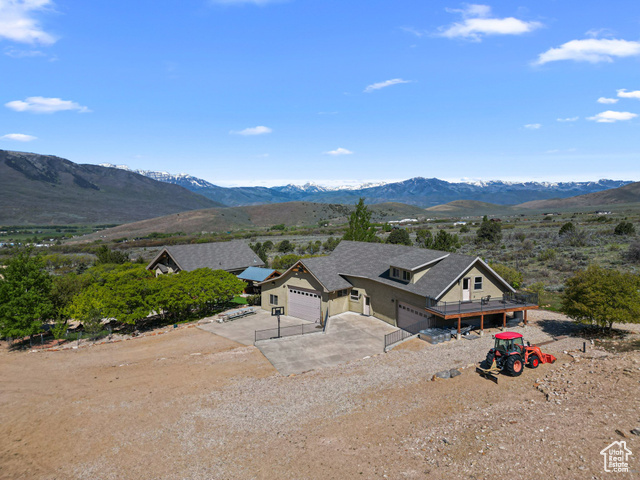 865 S GUILDED OAK RD E Wallsburg, Utah This is the location for your dream home, with solitude and views. An amazing location with plenty of space and seclusion. Owner built three garages plus living space and had plans for a large primary home. Trails are all over the property for walking or ATV's and only minutes to thousands of state and forest land. Expansive wrap around decks perfect for the amazing sunrises and sunsets in this beautiful valley. Fully fenced with great play areas designed for exploration and fun. A great well producing delicious Wallsburg water and a 10,000 gallon water storage tank. Take advantage of this opportunity now to move full time under the blue skies of the Wasatch Back or use it for an amazing family or corporate retreat.