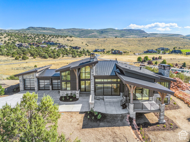 3035 CORRAL PEAK CIR 148 Heber City, Utah Well crafted and thoughtful design in this Red Ledges home featuring Mt. Timpanogos views that elevated this open and bright new construction home. Wasatch Mountain and the foothills surrounding Red Ledges are captured from many of the large windows throughout the home. Main level primary bedroom and second bedroom or office/study make the home comfortable for one level living. Plenty of entertaining space on the lower level with wet bar and gaming area, and an additional three bedrooms for family or guests.