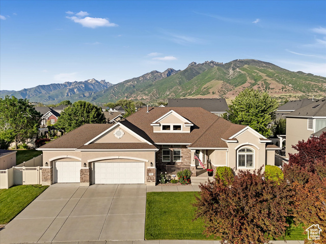 Proudly maintained and thoughtfully updated by its original owners, this exceptional luxury residence is nestled in the heart of Draper's prestigious Bellevue neighborhood-an area celebrated for its beauty, convenience, and unbeatable lifestyle. Perfectly positioned between Salt Lake City and Utah Valley allowing for a short drive north or south. It is also close to top-rated schools including Corner Canyon High, premier shopping, fine dining, and world-class ski resorts. Whether you're an outdoor enthusiast, commuter, or simply someone who appreciates both city convenience and natural serenity, this location offers it all, with Draper's renowned parks and trail system just steps away. The home's classic exterior, featuring a blend of sleek stucco and timeless brick, is enhanced by professional landscaping, mature trees, and vibrant flower beds. Inside, a grand entryway with soaring ceilings welcomes you into a spacious, light-filled interior, where a custom milled wood stair railing and flexible den or formal living room add both function and style. Designed for true single-level living, the main floor also includes three spacious bedrooms, two and a half bathrooms, a dedicated laundry room, with warm designer finishes throughout. Plantation shutters and large windows bathe the space in natural light, highlighting the soft, neutral palette. The chef's kitchen features white cabinetry, granite countertops, stainless steel appliances-including a brand-new induction range, new dishwasher, newer microwave, double ovens, a pantry, and an included refrigerator. The large center island has counter seating plus it is adjacent to the welcoming dining area. From the open kitchen and great room you can step out to the deck for easy indoor/outdoor living. The luxurious primary suite boasts coffered ceilings, a spa-inspired bath with a soaking tub, separate shower, private water closet, and a generous walk-in closet. The expansive partially finished basement provides a large bedroom, a beautifully finished bathroom with quartz countertops, and a double vanity. There is also a cold storage room, under the steps storage, and a linen closet. With high ceilings and large windows, this space is ready for future expansion-ideal for creating additional bedrooms, a rec room, or a home theater. Outside, the fully fenced, park-like yard offers lush lawn, mature trees, landscape curbing, an automatic sprinkler system with drip irrigation, and a well-built deck. Additional features include a radon mitigation system and a hot water recirculation pump. As part of the Bellevue community, residents can also take advantage of the nearby Bellevue Park. Schedule your private showing today and experience refined living in one of Draper's most desirable neighborhoods.