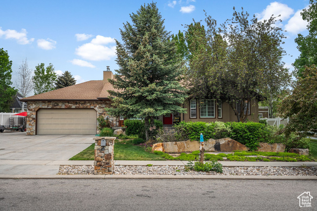 896 E 380 N Heber City, Utah Tucked in a quiet neighborhood just minutes from downtown Heber and mountain adventures, this spacious 5-bedroom, 3-bath home offers over 3,200 square feet of well-designed living. The main level welcomes you with hardwood floors, a stone-accented gas fireplace, and plantation shutters that add timeless charm. The kitchen features granite countertops, a tile backsplash, pantry storage, and Frigidaire appliances-flowing seamlessly into a dining area that opens to a Trex deck overlooking the backyard. The upstairs layout includes three bedrooms, including a bright primary suite with a walk-in closet, double vanity, and a beautifully tiled shower with dual showerheads. Downstairs, you'll find a family room, a second living area with a wood-burning stove set into a brick surround, two more bedrooms, and a full bathroom-plus potential to create a separate apartment with existing plumbing for a kitchen sink and laundry hookups. Outside, enjoy mature landscaping, a stone patio, and plenty of space for entertaining or relaxing. The oversized 2-car garage is complemented by a second garage with a workbench and shelving-perfect for storage or hobbies. With an extra-large driveway, there's room for RV or recreational parking. Located next to a park and just a short drive to Park City's world-class skiing, this home blends comfort, flexibility, and location.