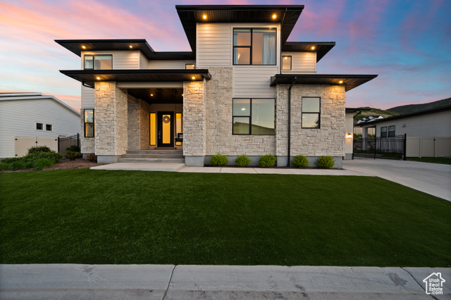 4771 W JUNIPER BEND CIR Herriman, Utah Inside the privacy of a well-maintained and gated community, thoughtful design and acute attention to detail are few of the many qualities that set his home apart. As you enter the main level, an entertainer's kitchen with ample storage, top tier appliances and an expansive island create a joyful environment to gather in. Custom cabinetry elevates the kitchen along with other thoughtful locations of the home and is further exemplified in the open and bright family room, home office and master closet. An island and en-suite washer and dryer bring class and convenience to the master suite, and the large primary bathroom's standalone soaking tub and beautifully tiled shower create a luxurious atmosphere. Upstairs three bedrooms, two full baths and an additional family and laundry room await, all with an abundance of natural light and high-end finishes. The basement adds more use and functionality with a home gym, large entertainment room, two more bedrooms with private bathrooms, a wet bar, laundry hook-ups and more. A robust whole-house water filtration system, interior and exterior surround sound, heated deck and Control4 Home Automation to streamline sound, lighting, and security take the space even further. The fully landscaped and low maintenance yard with a custom waterfall, putting green, fire pit, Bullfrog Spa and consistently beautiful turf lawn make the outside spaces equally as pleasing as the home's interior. All of these features and many others come together to create a space to be experienced. All furniture is also available for purchase.