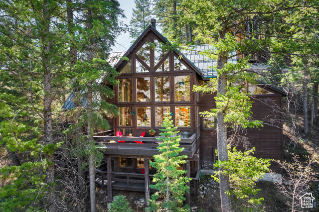 Owned for decades by renowned artist, Sibylle Szaggars Redford, this exquisite mountain sanctuary represents the essence of Robert Redford's original vision for development in, and around, the Sundance Resort: A minimal footprint and unpretentious, yet intentional design, that lives in harmony and communion with Nature; thus promoting creativity, freedom, and peace. The wooden cabin is embraced by majestic pines in the splendor of the surrounding forests, canyons, and the Wasatch Range. It enjoys extreme privacy at the end of the cul-de-sac and gated entry; with ever-changing views of Mt Timpanogos.  While the vicinity to the base of the mountain, and the Sundance Resort, make the home supremely convenient.   The main living area is anchored by 27-foot vaulted ceilings, wood-burning fireplace, and a full wall of windows that frame the mountains. With over 3,500 square feet, the layout includes four-bedroom suites, including a lower-level guest wing with private entrance, kitchenette, full bath, and deck. A lofted retreat provides flexible space for creative work or quiet reflection. Outdoor decks and expansive windows keep the surrounding forest and shifting light present throughout the home.    Owners enjoy year-round activities -enjoying summer hiking to majestic waterfalls, mountain biking, fly fishing and winter skiing and more.   This is a rare opportunity to own a legacy property near the Sundance Resort at a pivotal time. The resort is undergoing significant investment, a new high-speed lift, expanded snowmaking, upgraded dining, a new base camp, a new lodge, the Springs at Sundance, and improved year-round infrastructure. These changes are enhancing the experience while preserving the low-impact, nature-centered culture that reflect Robert Redford's original vision.   Homes with this level of privacy, architectural integrity, and ownership history rarely become available for sale.