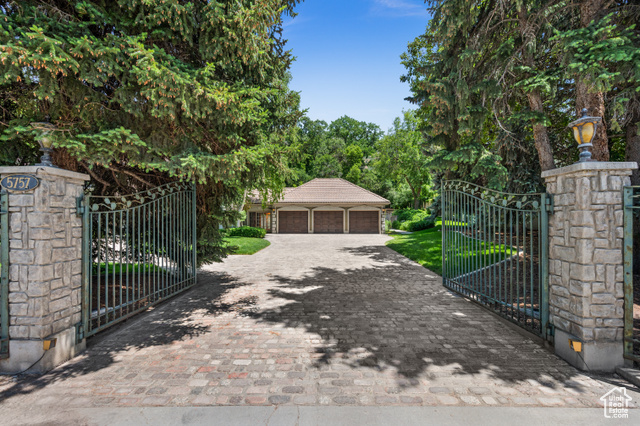 5757 S HOLLADAY BLVD E Holladay, Utah "THE HOLLADAY HOUSE" Exceptional European-style estate nestled in the heart of Holladay on a gated and secluded 1-acre lot. With over 5,600 square feet all above grade, this stunning residence offers 5 spacious bedrooms, 5 bathrooms, and unparalleled indoor and outdoor living spaces. Step into the grand 2-story layout where charm meets functionality. The main level spans over 3,000 square feet, showcasing a chef's kitchen with granite countertops, gas range, double wall ovens, walk-in pantry, and built-in appliances including a compactor. The spacious primary suite, located on the second floor, includes a sitting area with a cozy fireplace, vaulted ceilings, jetted tub, separate shower, and walk-in closet. The home is equipped with modern comforts like central air (electric), forced air gas heating, instant hot water, central vacuum, and built-in speakers on the main level and in the primary suite. Additional features include plantation shutters, wet bar, alarm systems (fire and security), and French doors leading to lush outdoor spaces. The landscaping is a showstopper, with fruit trees, vegetable gardens, pines, mature trees, scrub oak, terraced yard, and a waterfall and pond feature. Entertain year-round in the heated in-ground fiberglass/vinyl saltwater pool with an automatic cover and adjacent covered patio. The property also includes a garden/potting cottage, and a 3-car attached garage with overhead storage and ample guest parking. Flooring throughout includes carpet, marble, and tile. The basement is a crawl space-no unfinished areas, meaning all square footage is livable and finished above grade. Exterior features include stucco siding, bay windows, double-pane windows, and exterior lighting. Inclusions: Two sets washers & dryers, refrigerator, microwave, gas dryer hookup, ceiling fans, humidifier, and bar refrigerator. Also Included is patio furniture with a sofa, two chairs and a large dining table with six chairs. Enjoy the theatre area with an adjacent bar area. Included is seating for four. Location perks: Enjoy peace and privacy while being just minutes from Holladay Village, top-rated schools, ski resorts, shopping, dining, and freeway access. This rare Holladay gem offers the perfect blend of old-world charm and modern luxury. A must-see for the discerning buyer. You'll love the mountain views too!
