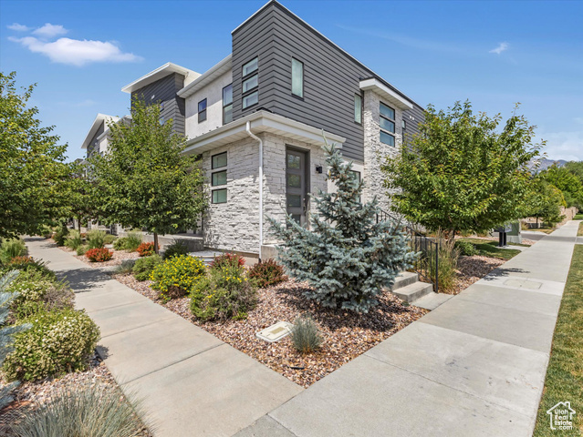 9217 S HOLIDAY BOWL CT E Sandy, Utah Perfect for both full-time residents and investors, this stylish townhome offers unbeatable access to Utah's best recreation, dining, and entertainment. Located just 5.6 miles from Little Cottonwood Canyon and 7.8 miles from Big Cottonwood Canyon, outdoor adventure is always close. You'll also enjoy being just 1.3 miles from Dimple Dell Regional Park and close to the Sandy Amphitheater. Perfect for concerts, food trucks, and summer fun. The inviting front porch, framed by eco-friendly landscaping, is ideal for relaxing, grilling, or gardening. The community includes green space with a pergola and picnic area, great for casual gatherings. Inside, the open-concept layout features a spacious kitchen with granite countertops, a large island, dark and sleek stainless steel appliances, and a glass-top stove. Upstairs, 12-foot ceilings add natural light and airiness. The primary suite includes a luxurious ensuite with double vanity, a huge soaking tub, separate shower, and walk-in closet. A water softener system adds spa-like comfort. Two additional bedrooms offer flexible space for guests, an office, or home gym. The upgraded laundry room includes cabinetry, drying racks, and a large-capacity washer. The finished basement provides a bonus room perfect for a media room or 4th bedroom, with plumbing ready for a full bath. Additional highlights include a two-car garage with 9-ft doors, ceiling-mounted storage, a smart opener, and a passive radon system. Tech upgrades include Google Fiber wiring, Nest doorbell, keypad entry, and smart thermostat. The HOA allows both short- and long-term rentals, making this a rare, versatile opportunity in a high-demand location.
